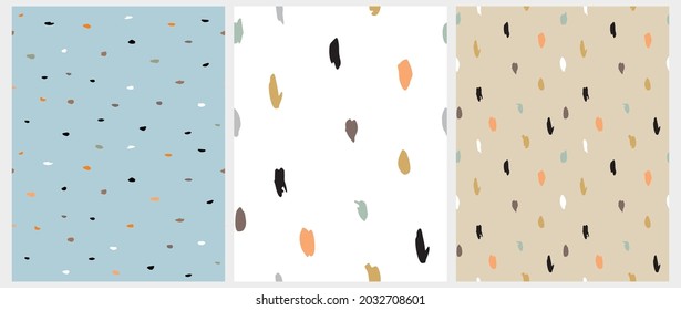 Abstract Geometric Seamless Vector Patterns. White, Orange, Gold, Black and Blue Brush Raindrops on a White, Blue and Ligt Gold Background. Irregular Spots Repeatable Print ideal for Fabric, Textile. 
