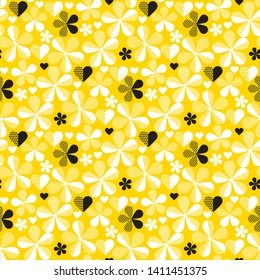 Abstract geometric yellow seamless pattern with flowers and hearts. Ditsy background of small white flowers and black leaves. Small-scale flowers scattered over a yellow background.