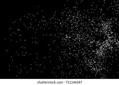 Abstract grainy texture isolated on black background. Top view. Dust, sand blow or bread crumbs. Silhouette of food flakes such as salt or almond or wheat flour spread on the flat surface or table. 