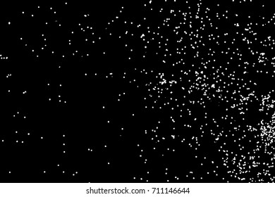 Abstract grainy texture isolated on black background. Top view. Dust, sand blow or bread crumbs. Silhouette of food flakes such as salt or almond or wheat flour spread on the flat surface or table. 