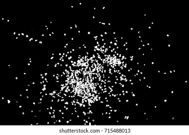 Abstract grainy texture isolated on black background. Top view. Dust, sand blow or bread crumbs. Silhouette of food flakes such as salt or almond or wheat flour spread on the flat surface or table. 