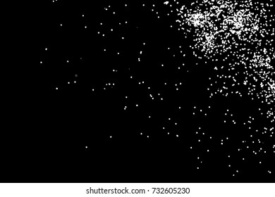 Abstract grainy texture isolated on black background. Top view. Dust, sand blow or bread crumbs. Silhouette of food flakes such as salt or almond or wheat flour spread on the flat surface or table. 