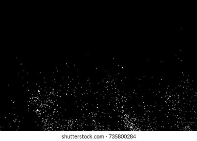 Abstract grainy texture isolated on black background. Top view. Dust, sand blow or bread crumbs. Silhouette of food flakes such as salt or almond or wheat flour spread on the flat surface or table. 