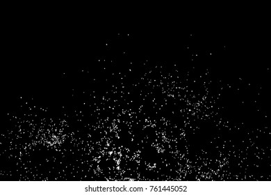 Abstract grainy texture isolated on black background. Top view. Dust, sand blow or bread crumbs. Silhouette of food flakes such as salt or almond or wheat flour spread on the flat surface or table. 