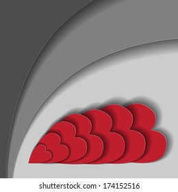 abstract gray background with red hearts from paper