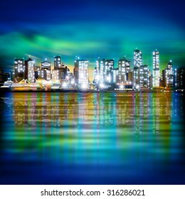 abstract green blue sky background with panorama of illuminated city by night
