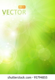 Abstract green blurry background with overlying semitransparent circles, light effects and sun burst. Great spring or green environmental background. Space for your text. EPS10