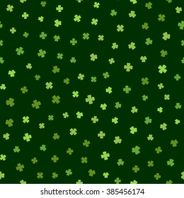 Abstract green seamless pattern for St. Patricks day from the clover leaves on green background. Design for banner, card, invitation, postcard, textile, fabric, wrapping paper. Vector illustration.