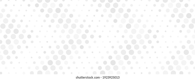 Abstract halftone background made of dots of different sizes in gray colors