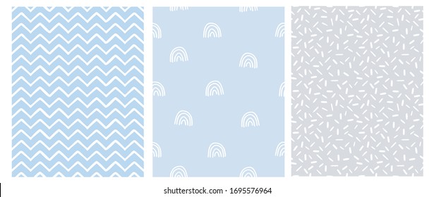 Abstract Hand Drawn Childish Style Seamless Vector Patterns. White Rainbows, Chevron and Spots on a Gray and Blue Background. Simple Irregular Geometric Vector Prints. Pastel Color Design.