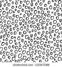 abstract hand drawn seamless pattern, black rough round doodles on a white background
