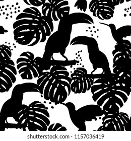 Abstract hand painted seamless animal background.Isolated birds with palm leaves and flowers. Black silhouettes of toucans birds pattern. Vector illustration.