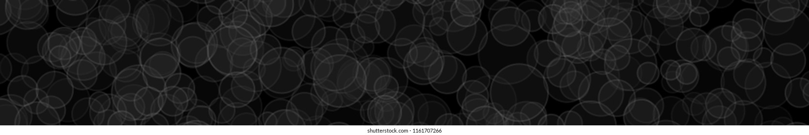 Abstract horizontal banner or background of randomly distributed translucent circles with outlines in black and gray colors.