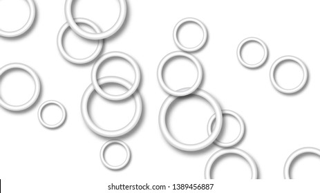 Abstract illustration of randomly arranged gray rings with soft shadows on white background