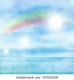 Abstract image of a rainbow on blue sky with sun glare.