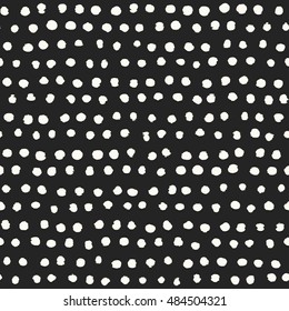 Abstract irregular dots textured background. Seamless pattern.
