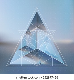 Abstract isometric pyramid with the reflection of the environment and low poly triangles on blurred background. Vector multifunctional blurry backdrop.