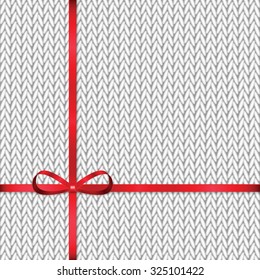 Abstract knitted pattern with red ribbon.Celebratory background