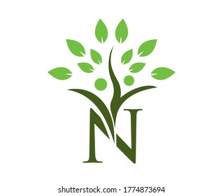 abstract letter N with tree leave on top. letter N logo with tree leave HUMAN.