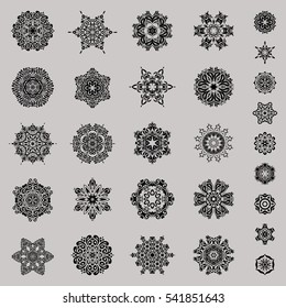 Abstract minimal set of twenty nine vector snowflakes on a gray background.