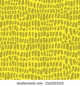 Abstract modern crocodile leather seamless pattern. Animals trendy background. Yellow decorative vector illustration for print, fabric, textile. Modern ornament of stylized alligator skin.