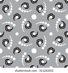 Abstract modern decorative seamless pattern with black and white shades circle and twirl elements on gray background
