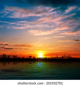 abstract nature background with panorama of city clouds and red sunset