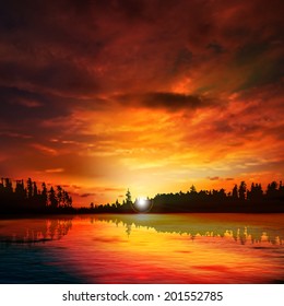 abstract nature dark background with forest lake red sunset and clouds