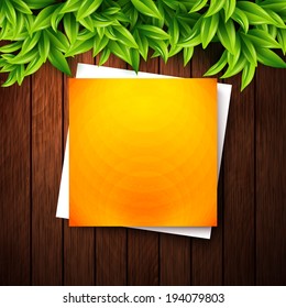 Abstract orange note paper on wooden background and leaves for your advertisement. Vector illustration. 