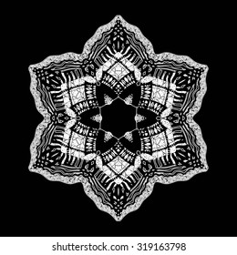 Abstract ornament . Lacy flower on black background. Vector illustration.