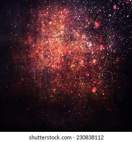 Abstract painted red background with grunge texture and falling stars lighting effect.