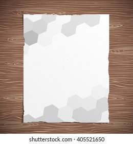 Abstract polygon torn paper brochure, flyer is stuck on wooden desk