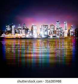 abstract purple sky background with panorama of illuminated city by night