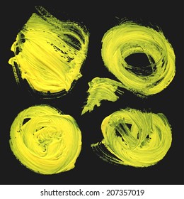Abstract realistic strokes and circles drawn thick yellow paint on black background