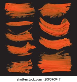 Abstract realistic strokes drawn thick orange paint on black paper