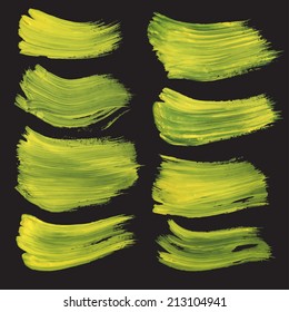 Abstract realistic strokes drawn thick yellow paint on black paper