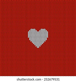 Abstract red background with white knitted heart