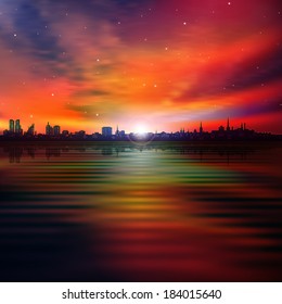 abstract red sunset background with silhouette of city and clouds