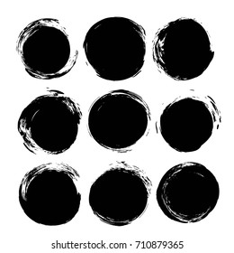 Abstract round black ink textured brush strokes isolated on a white background