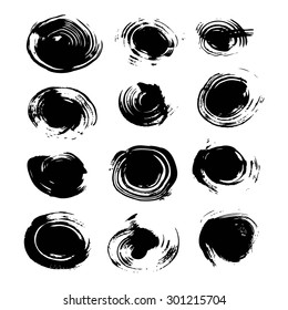 Abstract round spots of black paint and ink isolated on a white background