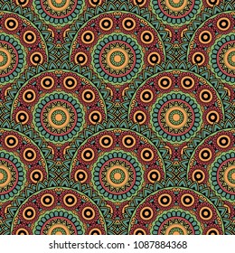 Abstract seamless backdrop. Round colorful texture in green, blue, yellow and red colors. Mandala background. Oriental pattern for design