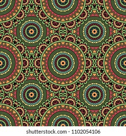 Abstract seamless backdrop. Round colorful texture in green, red  and blue colors. Mandala background. Oriental pattern for design