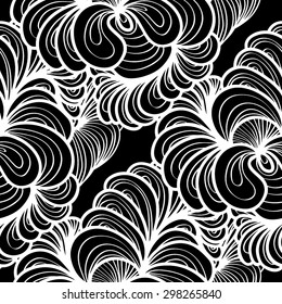 Abstract seamless background, vector illustration. Lacy monochromatic pattern with floral motifs.