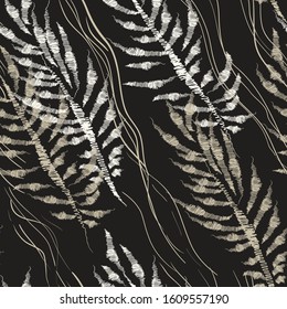 Abstract seamless floral pattern with stylized image of palm leaves, imitation of embroidery on fabric. Monochrome colors. White on a black background. Vector illustration.