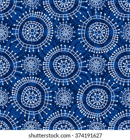 Abstract seamless geometric pattern in doodle style. White snowflakes on blue background, hand drawn, vector. For background design and decoration, wallpaper, packaging, fabrics, textiles.