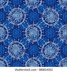 Abstract seamless geometric pattern in doodle style. White snowflakes and small circles on blue background, hand drawn. For background design and decoration, wallpaper, packaging, fabrics, textiles.