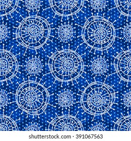 Abstract seamless geometric pattern in doodle style. White snowflakes and small circles on blue background, hand drawn. For background design and decoration, wallpaper, packaging, fabrics, textiles.