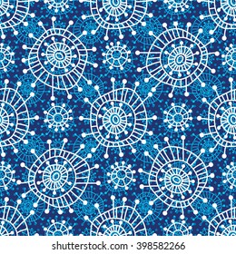 Abstract seamless geometric pattern in doodle style. White snowflakes and small circles on blue background, hand drawn. For background design and decoration, wallpaper, packaging, fabrics, textiles.