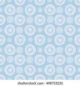 Abstract seamless geometric pattern in doodle style. White snowflakes and circles on blue background, hand drawn. For background design and decoration, wallpaper, packaging, fabrics, textiles.