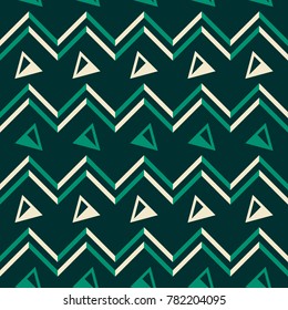 Abstract seamless geometric pattern in yellow and green colors with zigzags and triangles